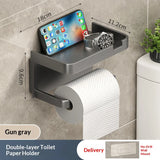 Wall-mounted organizer with phone stand, watch holder, and paper towel roll on a tiled wall.
